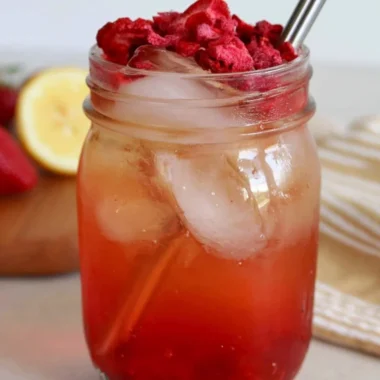 Iced Strawberry Green Tea in a glass with fresh strawberries