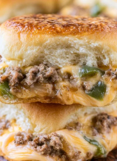 Delicious Philly cheesesteak sliders with beef, cheese, and toppings served on rolls.