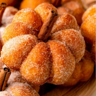 Freshly baked pumpkin donuts with colorful toppings