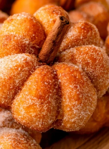 Freshly baked pumpkin donuts with colorful toppings