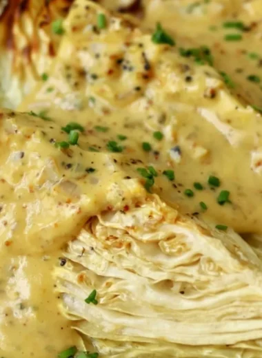 Roasted cabbage wedges with onion-Dijon sauce on a plate