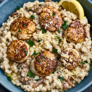 Delicious scallops served with creamy risotto on a plate