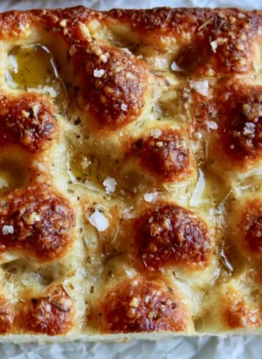 Freshly baked sourdough discard focaccia with herbs and olive oil