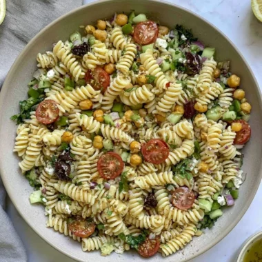Vegan Greek Pasta Salad with fresh vegetables and olives in a bowl