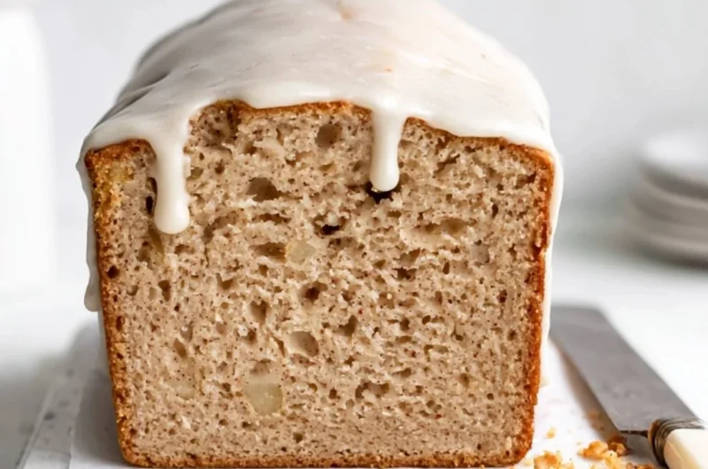 Delicious homemade Apple Spice Cake topped with cream and fresh apple slices.