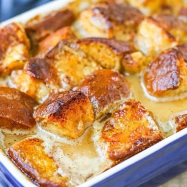 Delicious homemade bread pudding served in a bowl with a drizzle of sauce